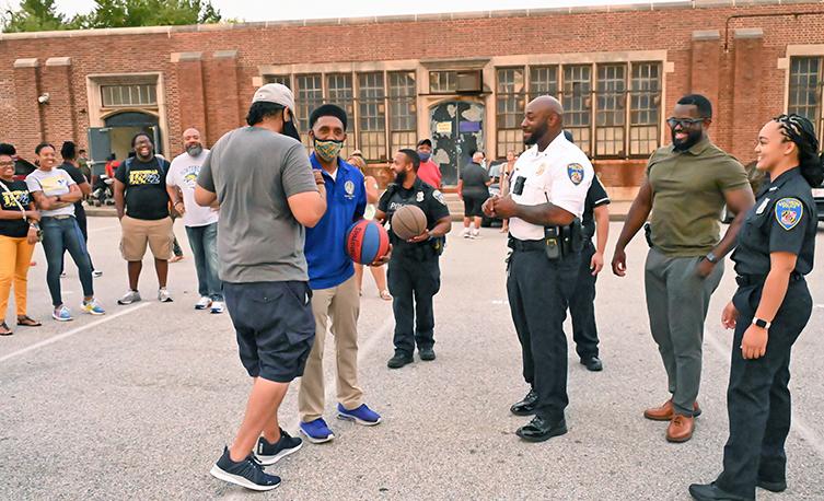 Baltimore police playing basketball with community members