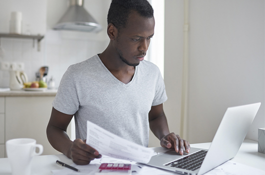 Young man paying bills