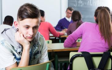 Sad teenager excluded in a classroom